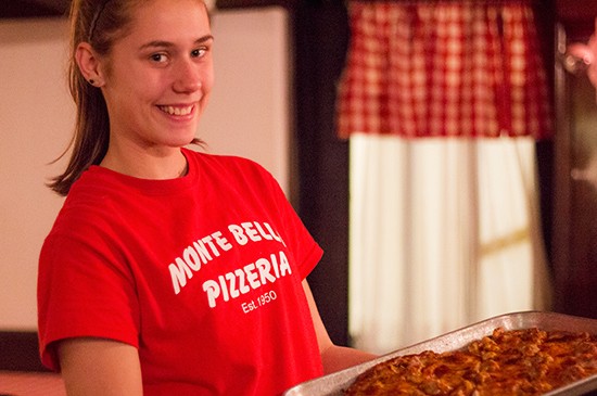 A friendly server will bring the freshly cooked pizza out on a metal sheet pan.