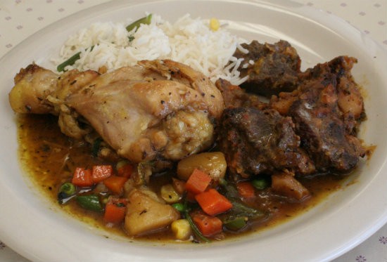 A plate from the buffet, which included roasted goat and chicken curry with rice - PHOTO BY JOHNNY FUGITT