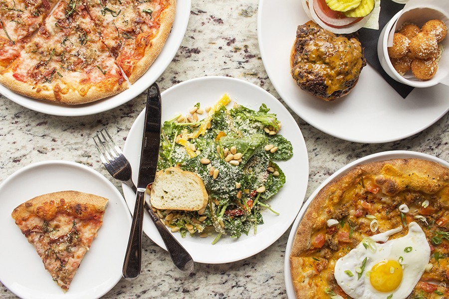 Scarlett’s “Meat Lover’s” and breakfast pizzas (top left and bottom right), shown with the “Scarlett Burger” and baby kale salad.