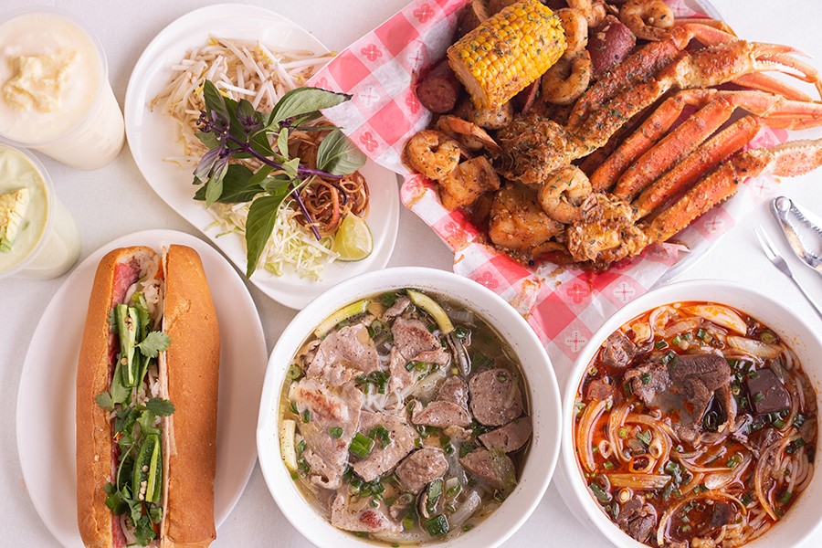 A selection of items from Joyful House, pictured from left to right, top to bottom: avocado smoothie, durian smoothie, a side of fresh herbs and bean sprouts to accent bowls of pho, seafood boil, bánh mì đặc biệt, phở tái bò viên and bún bò huế.