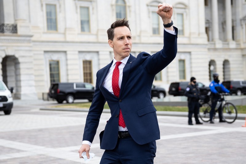 Sen. Josh Hawley (R-Mo.) gestures toward a crowd of supporters of President Donald Trump gathered outside the U.S. Capitol to protest the certification of President-elect Joe Biden's electoral college victory on Jan. 6, 2021. Some demonstrators later breached security and stormed the Capitol.