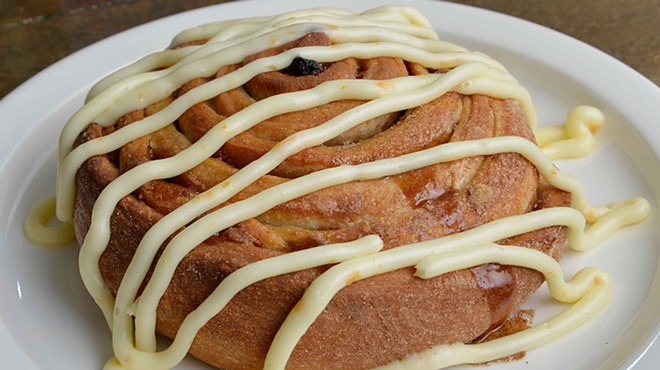 The "XL Cinnamon Roll" has raisins and pecans baked inside. On top is orange cream cheese icing.