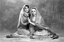 WUSTL PHOTO SERVICES - Ladies in waiting: Ann Marie Mohr (right) as - Andromache and Lindsay Brill (left) as Hecuba in - The Trojan Women.