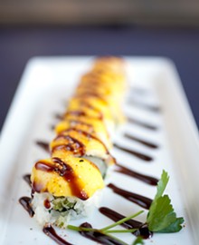 JENNIFER SILVERBERG - The Golden Child, one of Hiro's specialty rolls, with white tuna, tempura crunch, avocado and topped with mango and eel sauce.