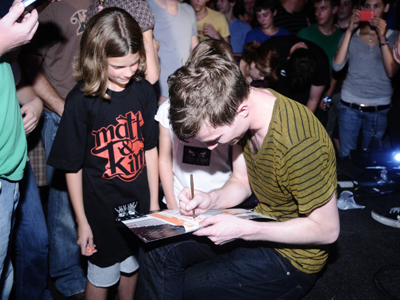 Matt signs an autograph for a young fan at the show's end.