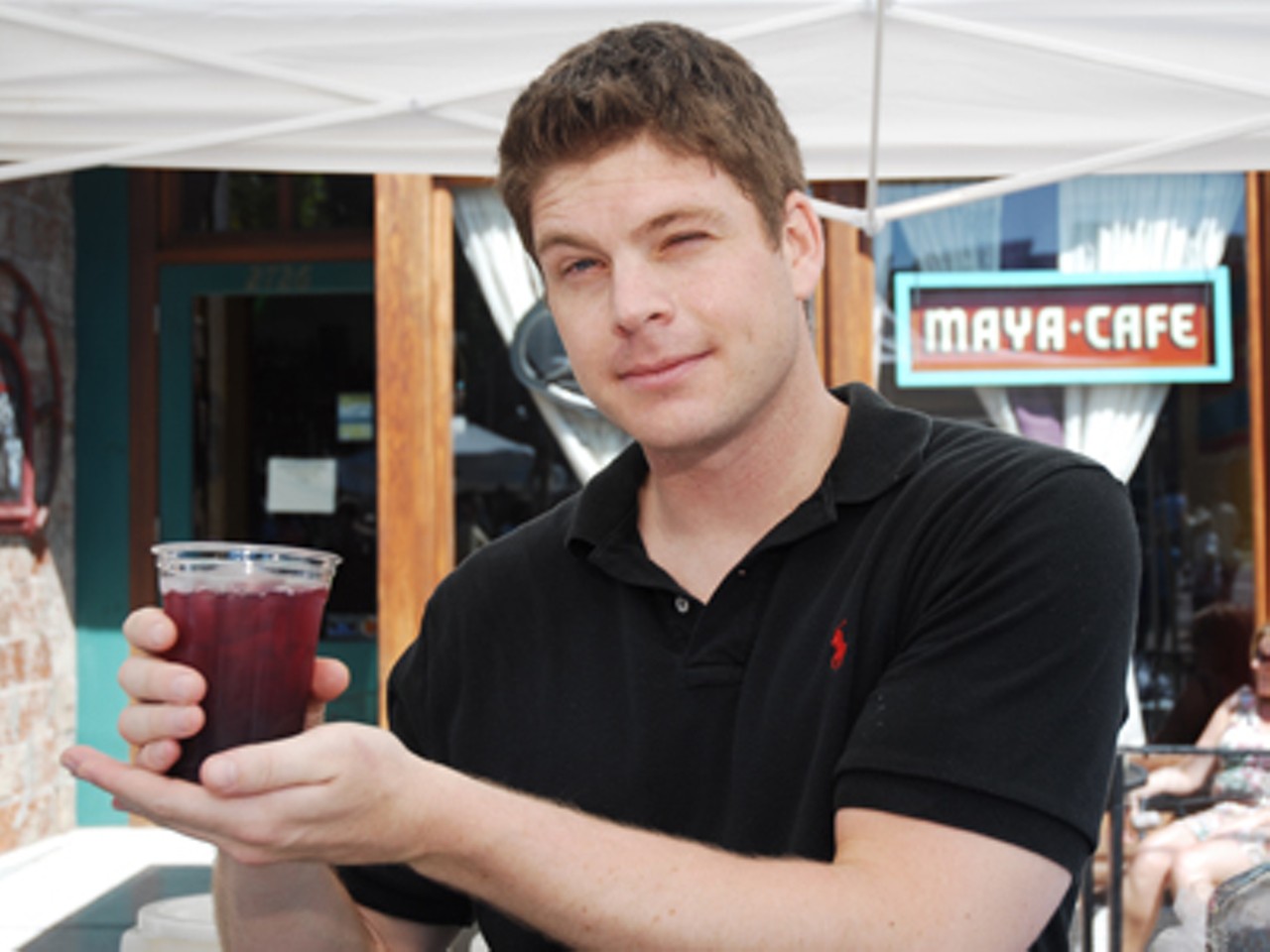 Maya Caf&eacute;'s bartender, Tripp Venneman, models the Sangria made completely of fresh squeezed ingredients. You might also try the Maplewoody, originated and only served at the Maya Cafe.