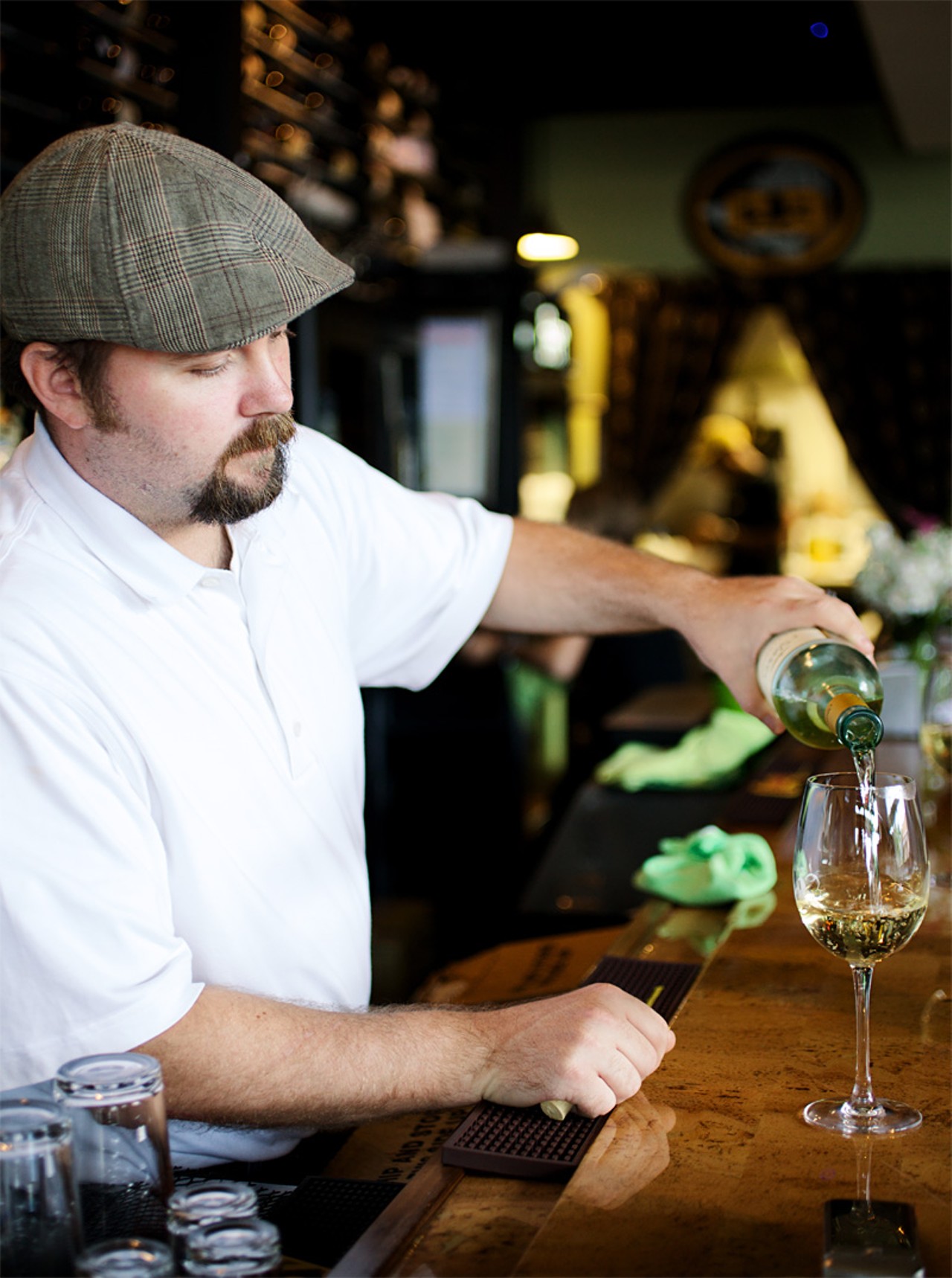 Owner Mike Lonero pouring a glass of wine at Cork Wine Bar.