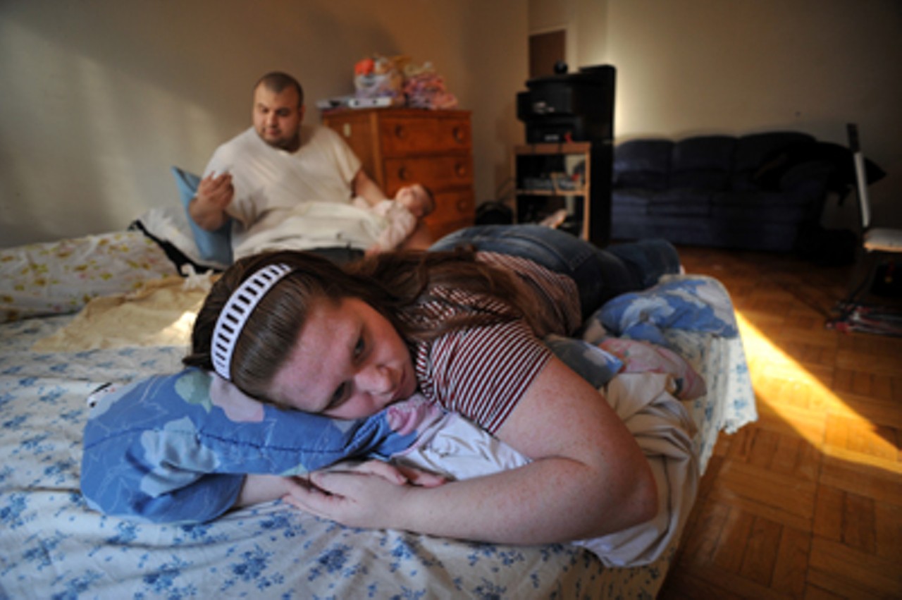Kim Rivera -- waiting news on her stay of deportation -- rests while her husband Mario tends to their baby, Katie, at their Toronto apartment.Read "No Canada: U.S. military deserters once again flock to Canada to avoid war. Looks like this time they picked the wrong country."