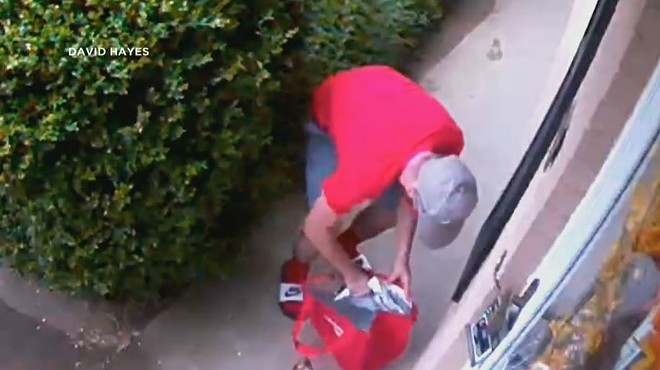 Security footage shows a porch pirate as he puts a white Amazon package into a DoorDash bag.