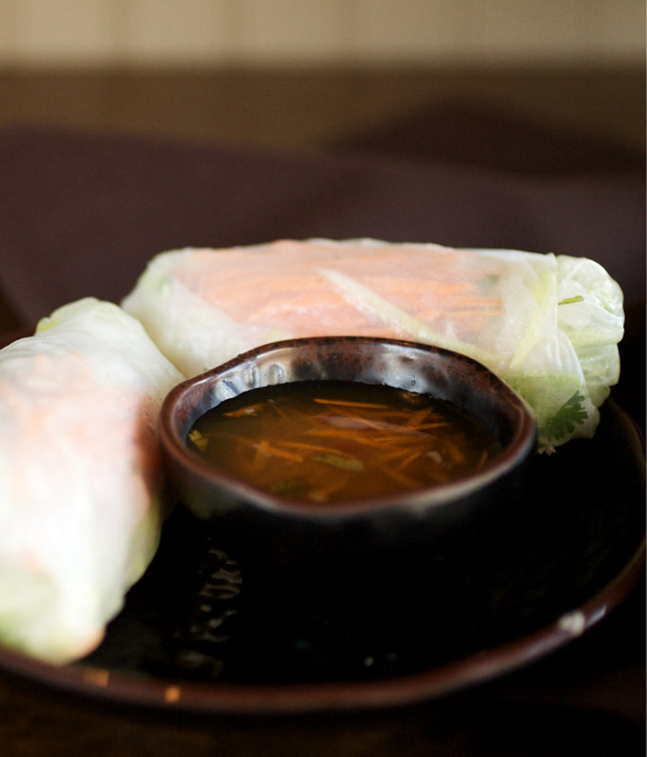 Wang Gang's Fresh Spring Rolls are prepared with shrimp, rice noodles, mint, Thai basil, cilantro and vegetables wrapped in rice paper. They are served with Nuoc Cham, a spicy Vietnamese dipping sauce.