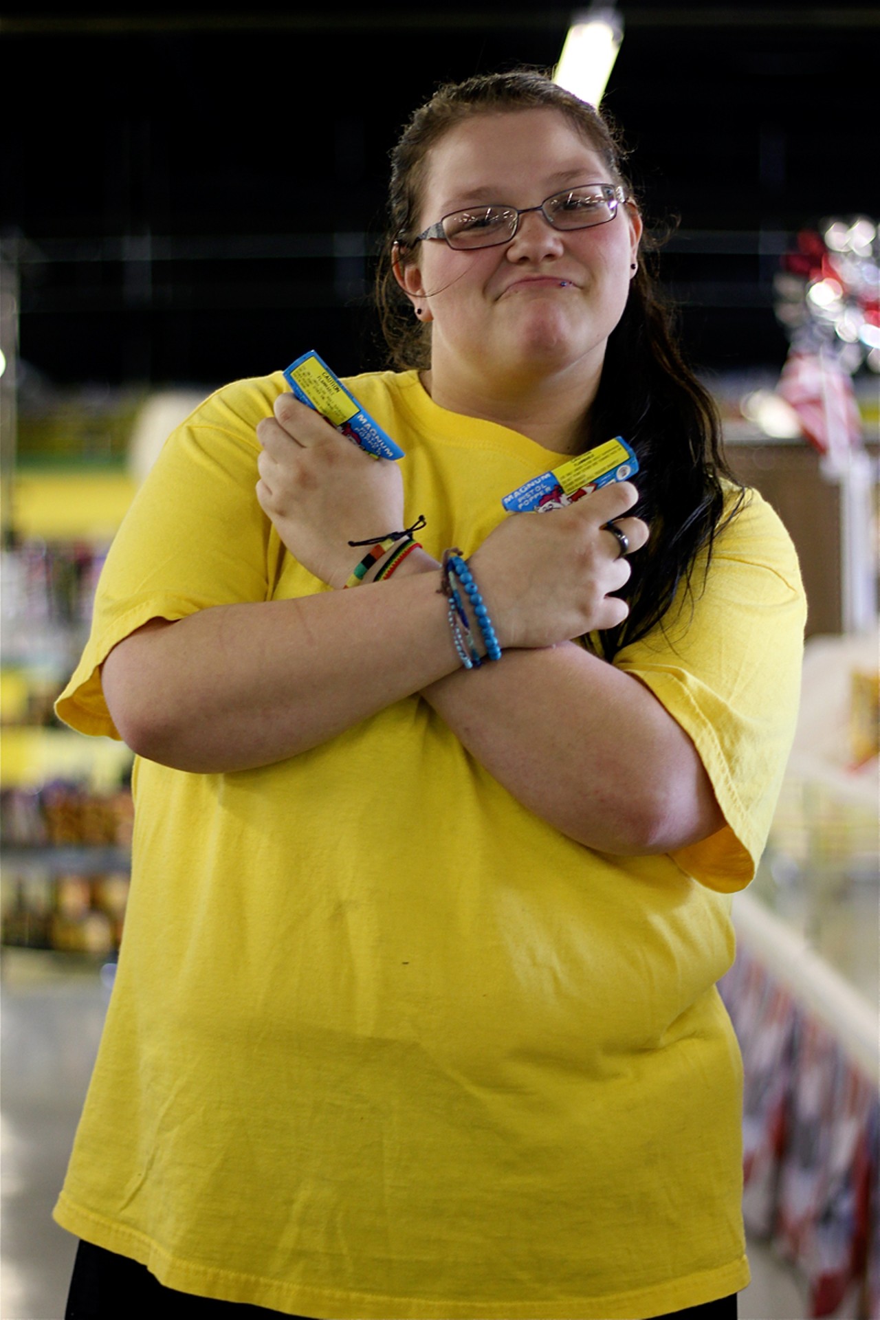 Fireworks World employee Sabrina Shinkle poses with her favorite firework, Magnum Pistol Popper. This is Shinkle's first season at Fireworks World.