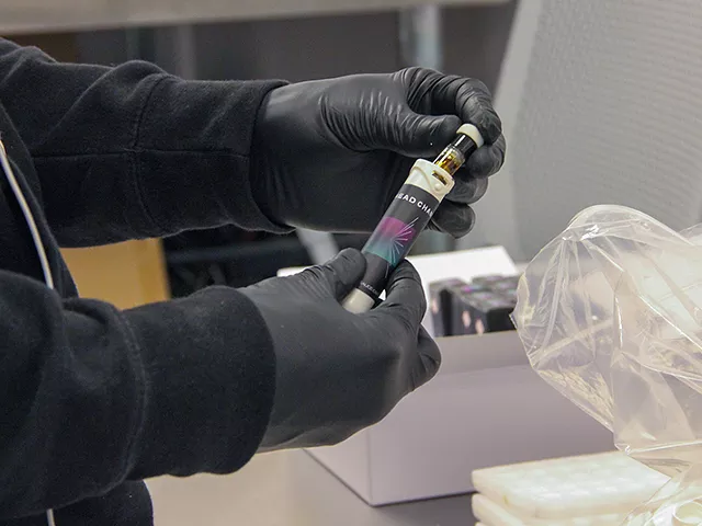 A Curador employee packages a Head Change "sauce cart" at the company's lab.